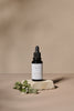 Botanic Boost Hyaluronic Serum dropper bottle with white label on a beige background