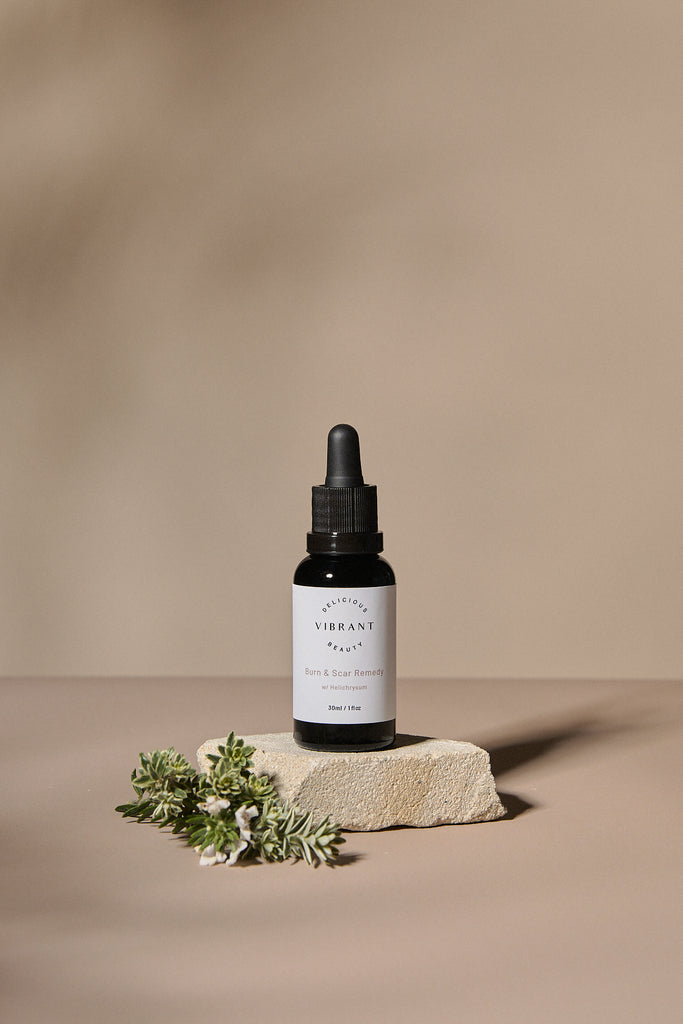 Black dropper bottle with white label on a beige background