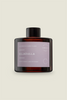 An amber reed diffuser bottle with a black cap, labeled 'Ulladulla', with Lavender & Ylang Ylang