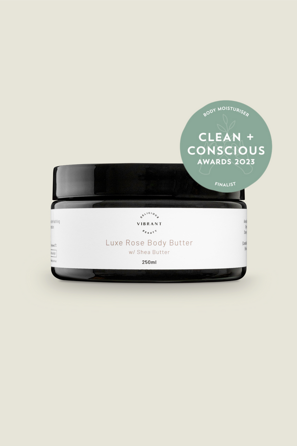 Luxe Rose Body Butter jar with a 'Clean + Conscious Awards' badge on a light beige background