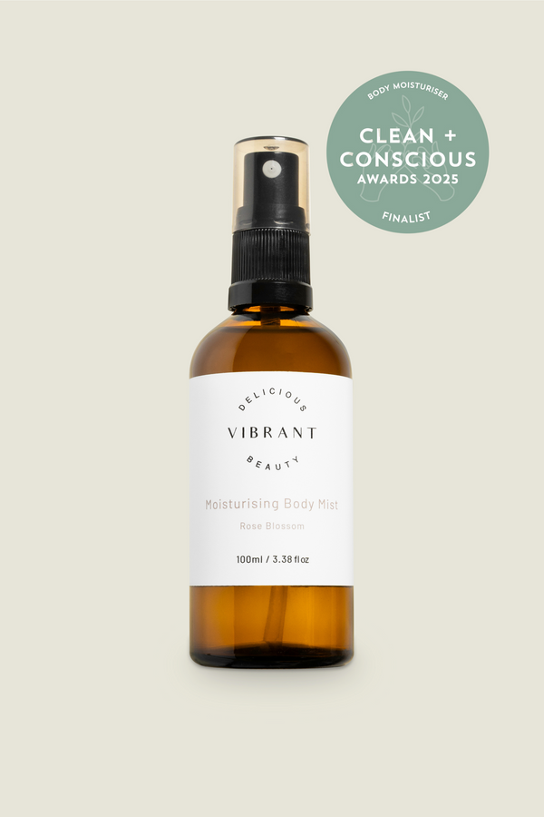 Brown bottle with a white label on a light gray background, featuring 'Delicious Vibrant Beauty' and 'Clean + Conscious Awards 2023 Finalist' badge.