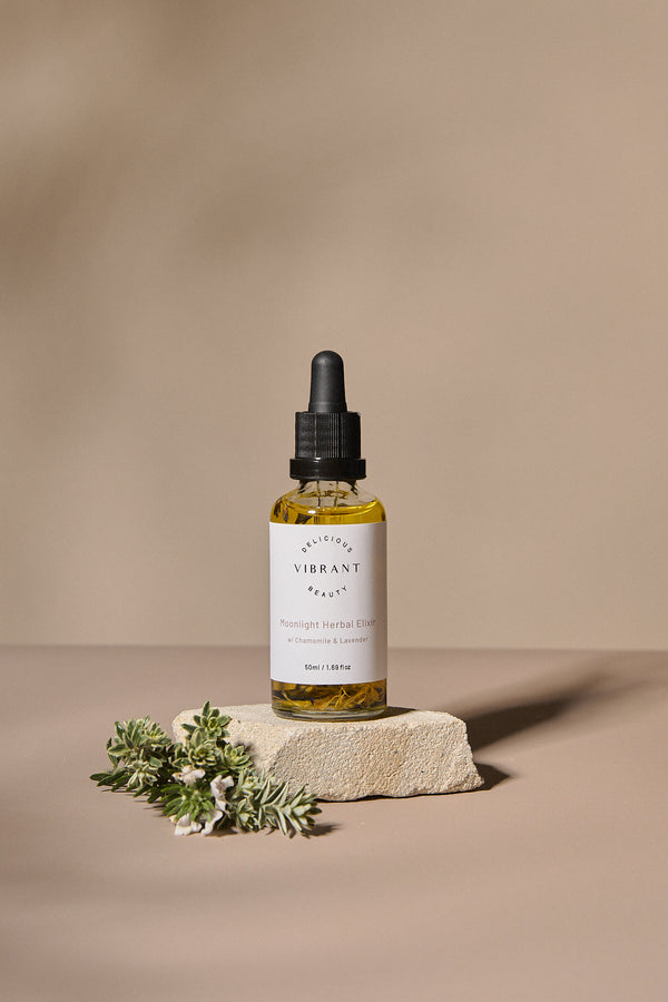 Bottle of Moonlight Herbal Elixir oil on a beige background