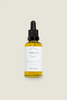 A clear glass bottle with a dropper, labelled 'DELICIOUS VIBRANT BEAUTY Hair Elixir', filled with yellow liquid.