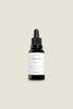 A black glass dropper bottle with a white label, containing Regeneration Beauty Elixir.