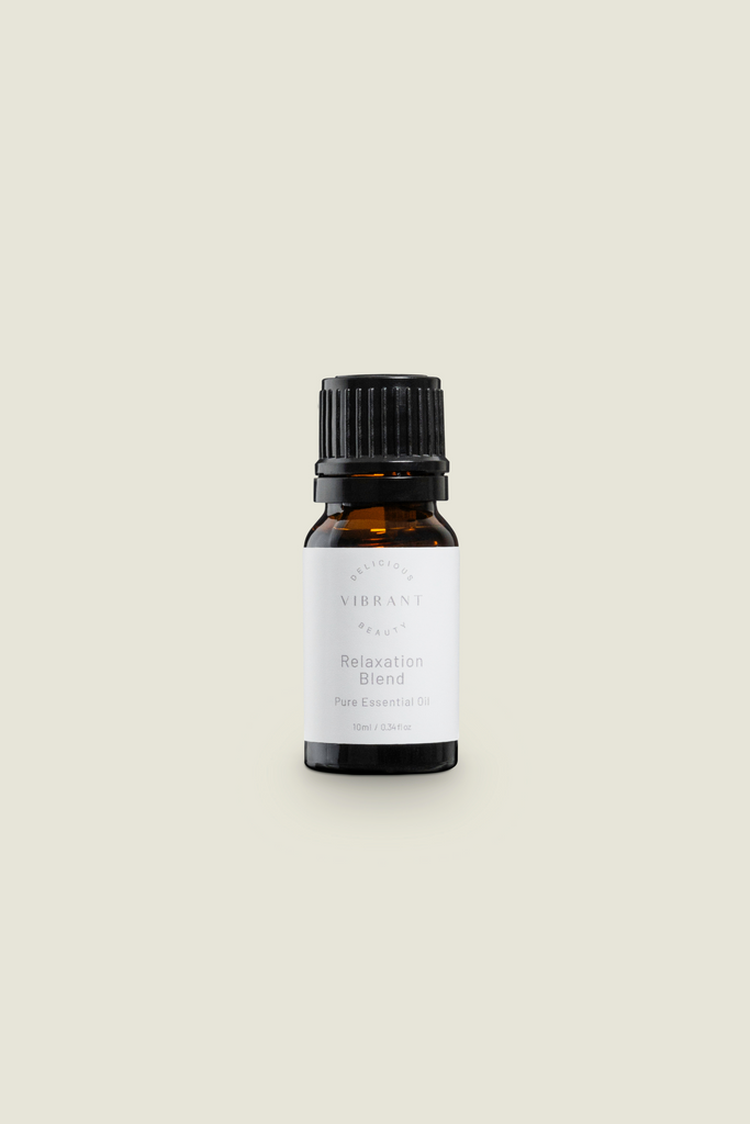 A small dark glass bottle with a black cap, labeled with 'Relaxation - Citrus, Lavender and Sandalwood Essential Oil'.