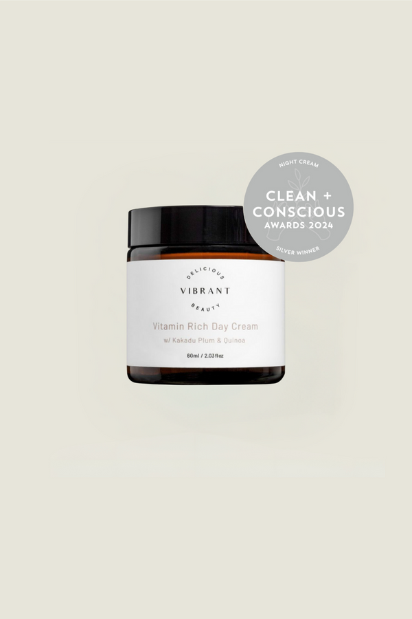 Jar of Vitamin Rich Day Cream with 'Clean + Conscious' award badge on a beige background